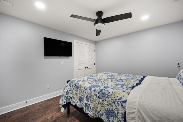 bedroom with ceiling fan, a closet, and dark hardwood / wood-style floors