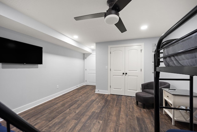 bedroom with ceiling fan, dark wood-type flooring, and a closet