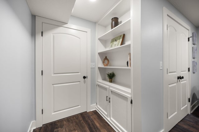 hallway with dark hardwood / wood-style flooring