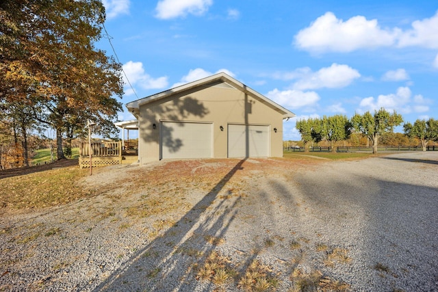 view of home's exterior with a garage and a deck