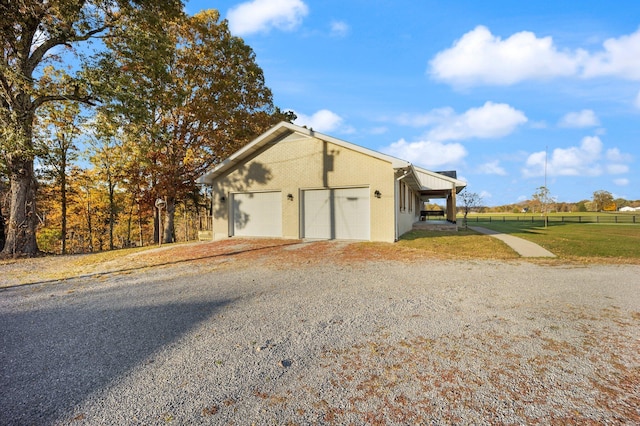 view of property exterior featuring a lawn and a garage