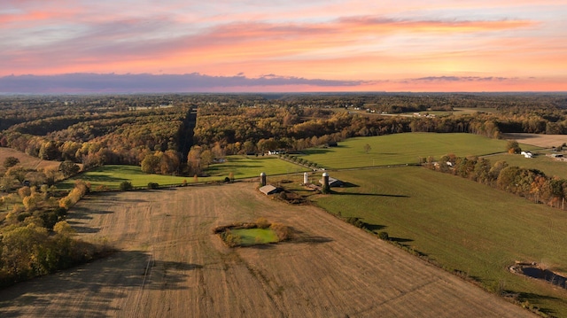 aerial view at dusk featuring a rural view