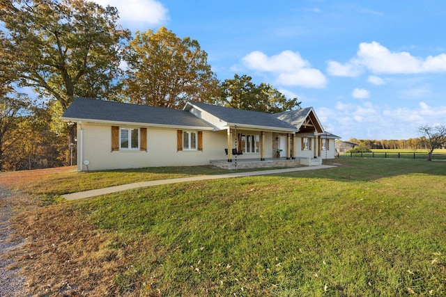 ranch-style house with a porch and a front lawn