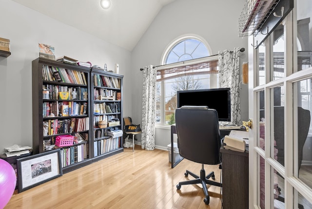 office featuring vaulted ceiling and hardwood / wood-style flooring