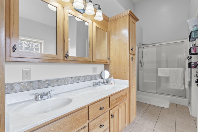 bathroom with tile patterned floors, vanity, and a shower with shower door