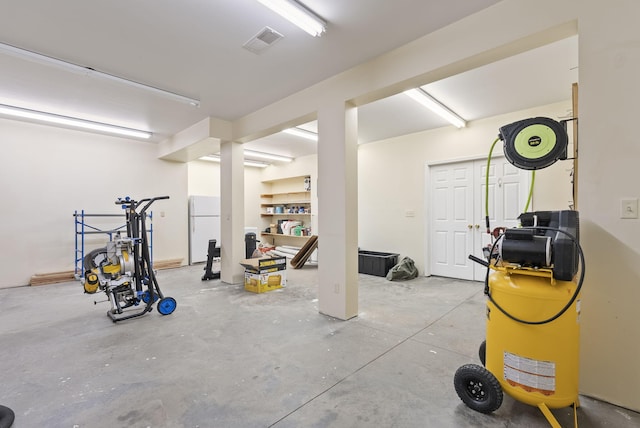 basement featuring white refrigerator