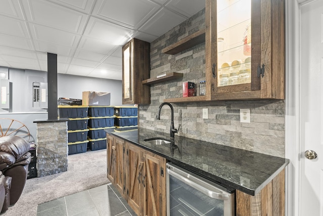 kitchen featuring tasteful backsplash, light colored carpet, beverage cooler, and sink