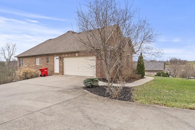 view of side of home with a yard and a garage