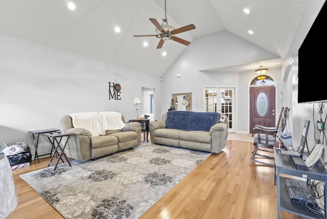 living room featuring ceiling fan, hardwood / wood-style floors, high vaulted ceiling, and french doors