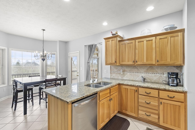 kitchen with an inviting chandelier, sink, stainless steel dishwasher, decorative backsplash, and light tile patterned floors