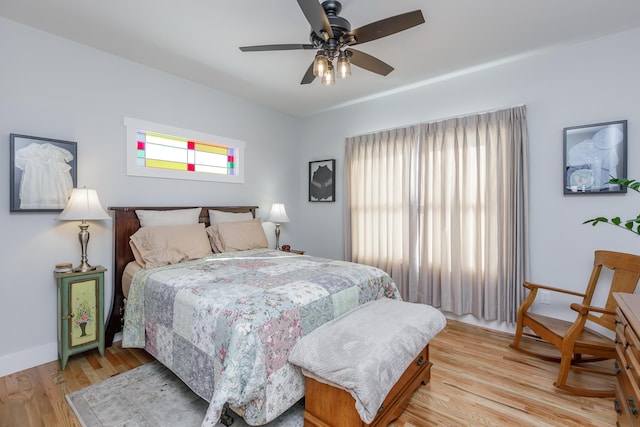 bedroom with light hardwood / wood-style floors and ceiling fan