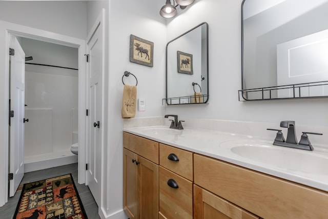 bathroom with vanity, toilet, and walk in shower