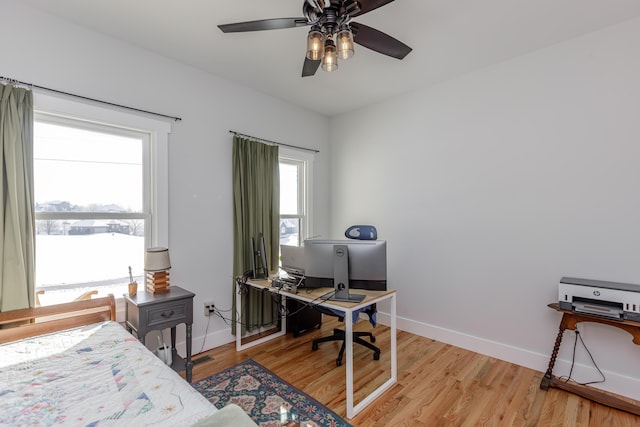 bedroom with light hardwood / wood-style flooring and ceiling fan