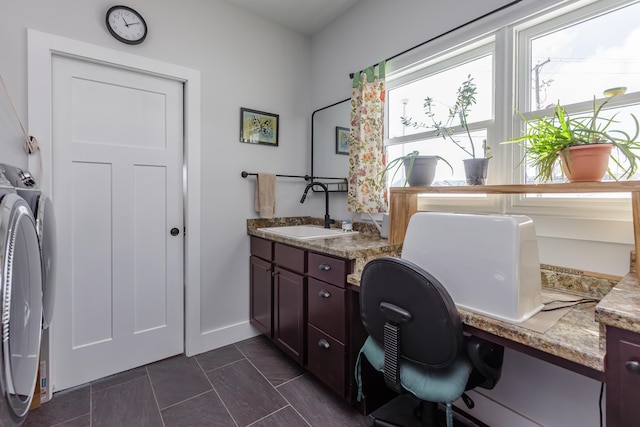 office area featuring separate washer and dryer and sink