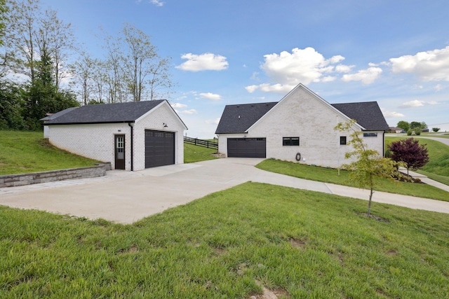 112 Tuscany Way, Richmond, KY 40475 - view of side of property with a yard, an outdoor structure, brick siding, a detached garage, and roof with shingles