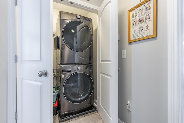 laundry room with stacked washer / dryer