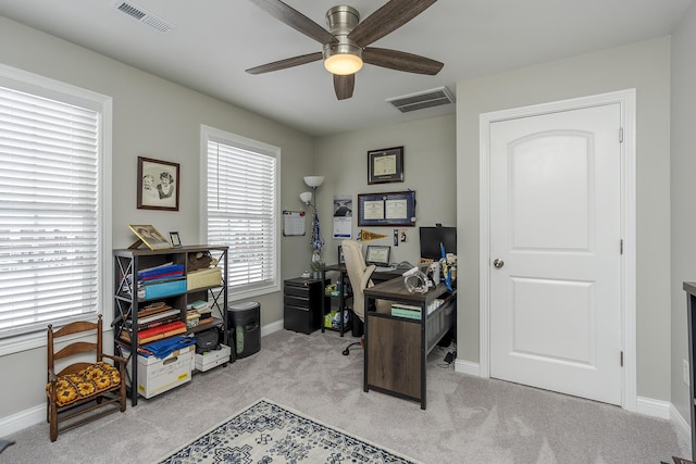 carpeted office with ceiling fan