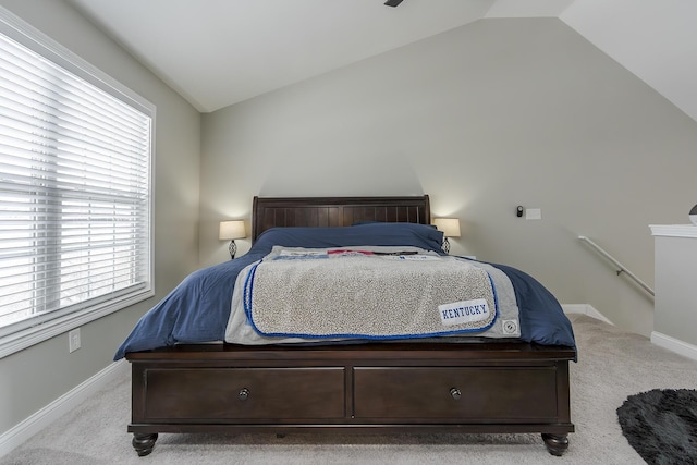 carpeted bedroom with lofted ceiling