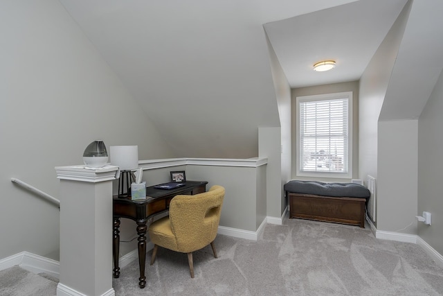 carpeted home office featuring vaulted ceiling