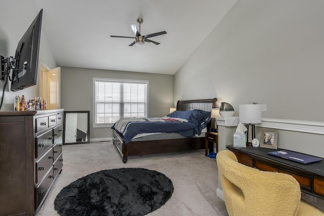 carpeted bedroom with ceiling fan and vaulted ceiling