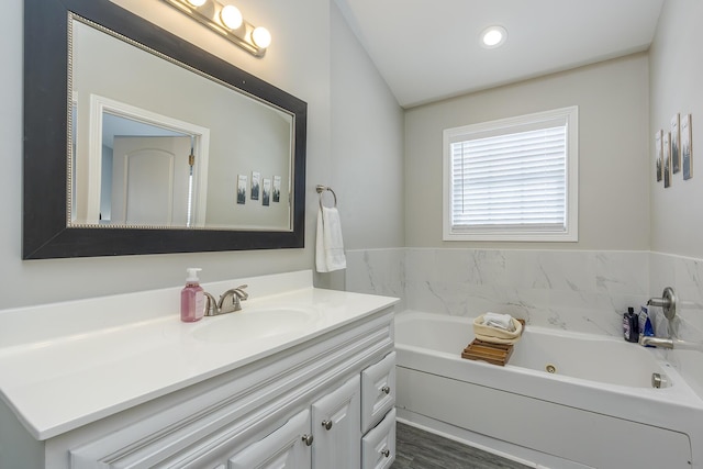 bathroom with vanity and a bathing tub