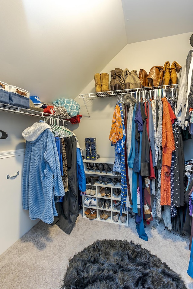 spacious closet with lofted ceiling and carpet floors