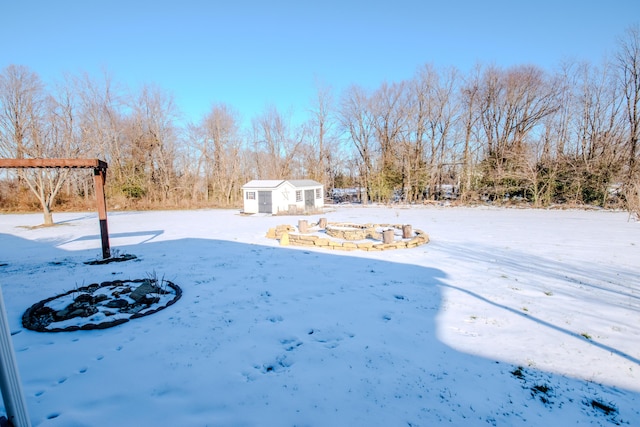 yard covered in snow featuring an outbuilding