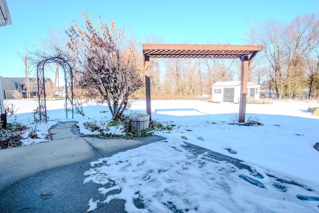 yard covered in snow with a shed