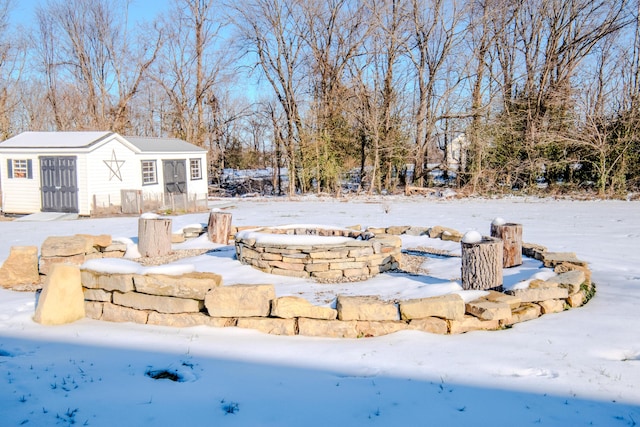 yard covered in snow featuring an outdoor structure