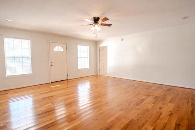 entryway with light wood-type flooring, ceiling fan, and ornamental molding