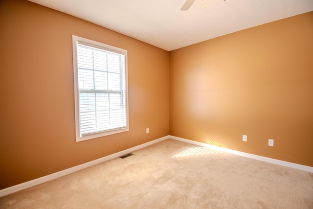 unfurnished room with ceiling fan and carpet flooring