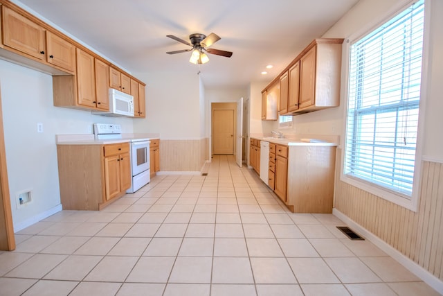 kitchen featuring white appliances, light brown cabinets, sink, ceiling fan, and light tile patterned floors