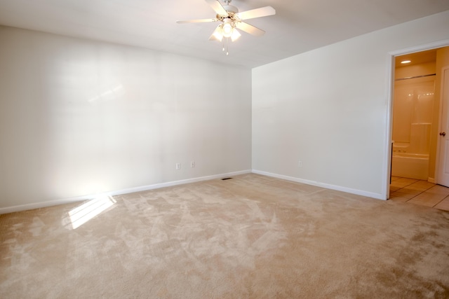 empty room featuring light carpet and ceiling fan