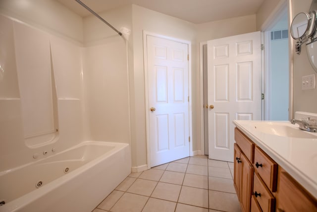 bathroom featuring tile patterned flooring, tub / shower combination, and vanity