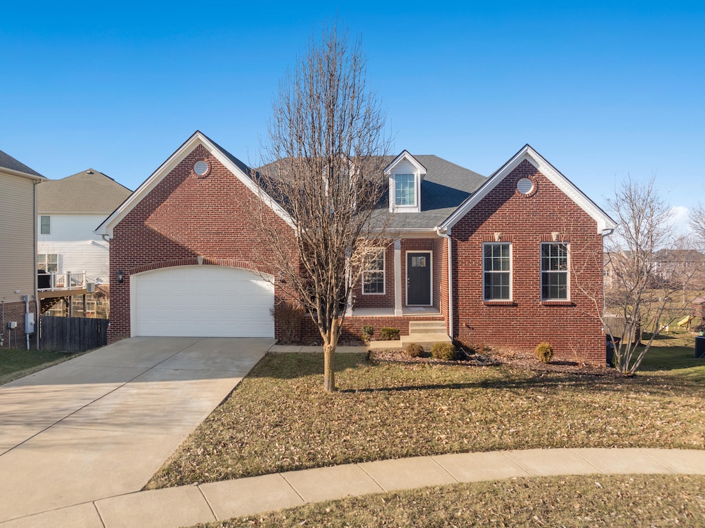 view of front of property with a garage and a front yard