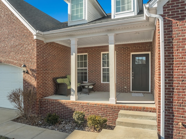 view of exterior entry with covered porch