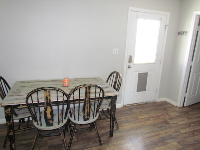 dining space with dark hardwood / wood-style flooring