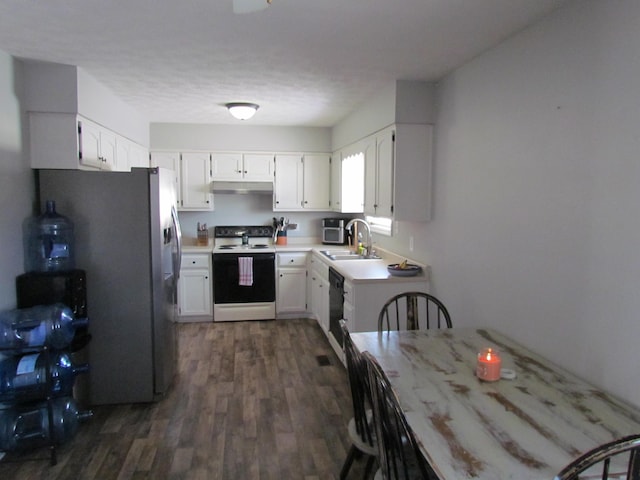 kitchen featuring dark wood-type flooring, sink, white cabinetry, stainless steel refrigerator, and electric stove