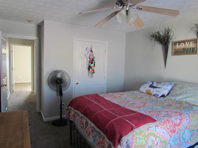 carpeted bedroom with a textured ceiling and ceiling fan