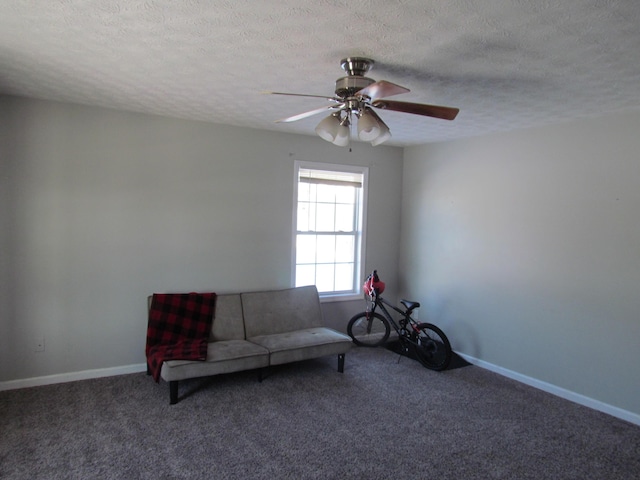 unfurnished room with ceiling fan, carpet floors, and a textured ceiling