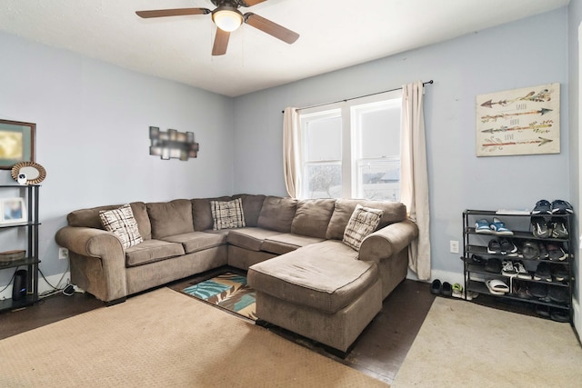 living room featuring dark carpet and ceiling fan