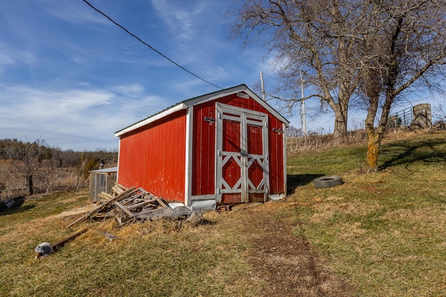 view of outbuilding featuring a yard