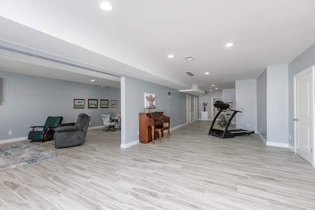 workout room featuring light hardwood / wood-style floors