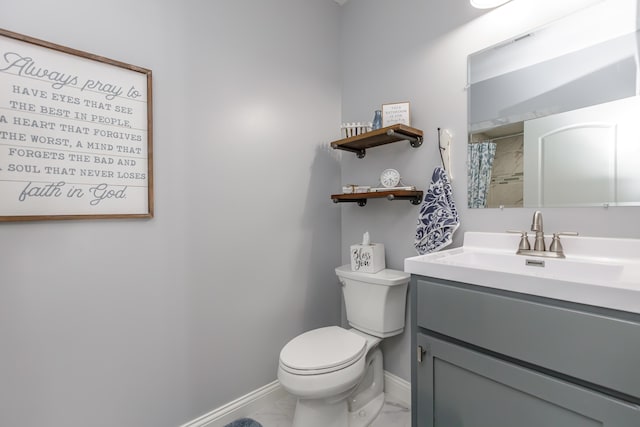 bathroom featuring toilet and vanity