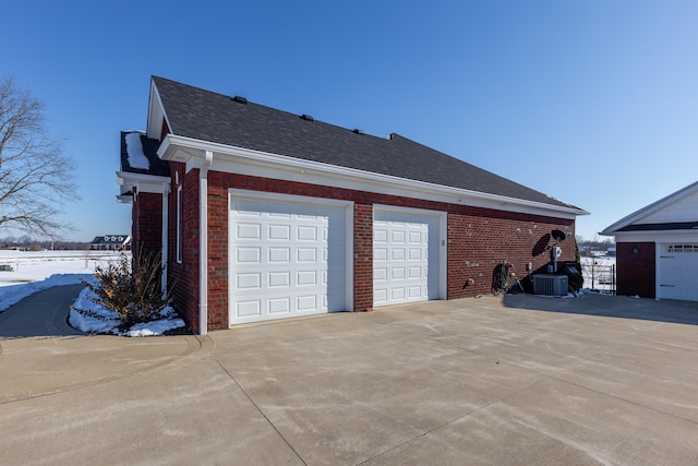 view of snowy exterior featuring a garage