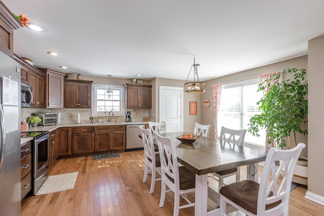 dining room featuring sink and light hardwood / wood-style flooring