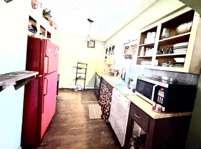 kitchen with refrigerator, white dishwasher, sink, electric stove, and pendant lighting