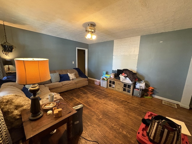 living room with hardwood / wood-style flooring and a textured ceiling