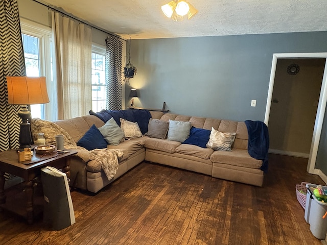 living room featuring dark hardwood / wood-style flooring and a textured ceiling