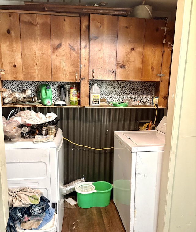 laundry room with washer and dryer and wood-type flooring